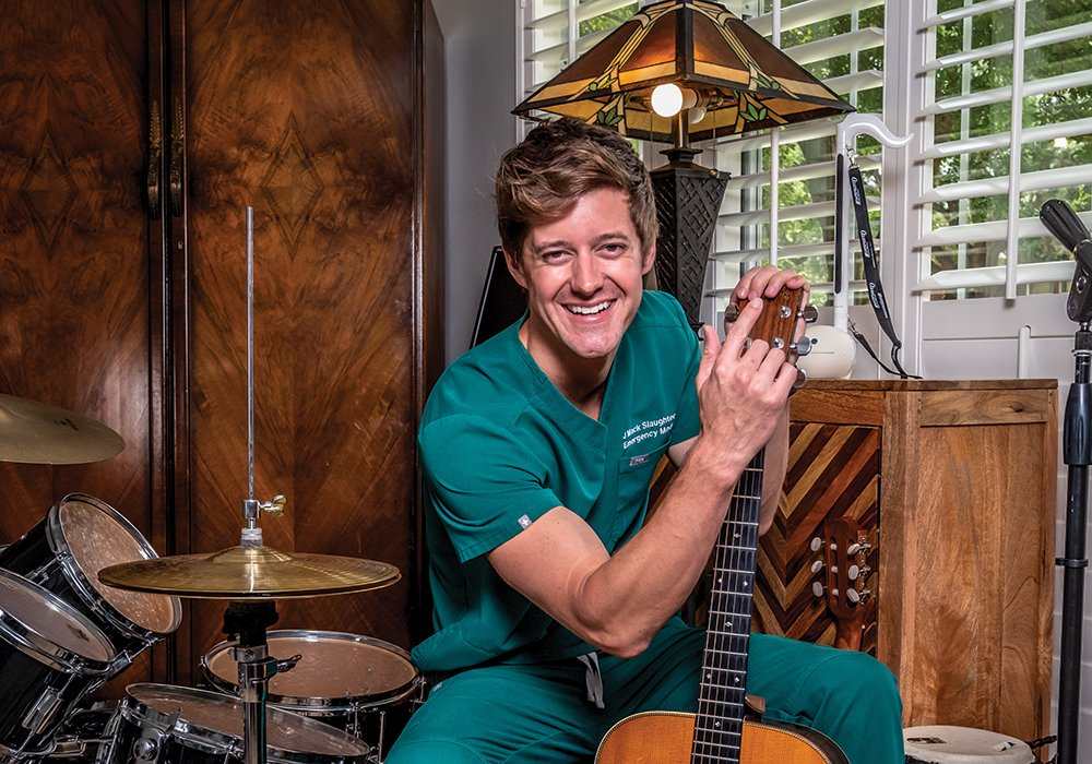 Dr. J. Mack Slaughter Jr. holding a guitar
